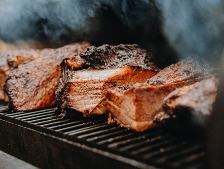 Meat on a grill with steam