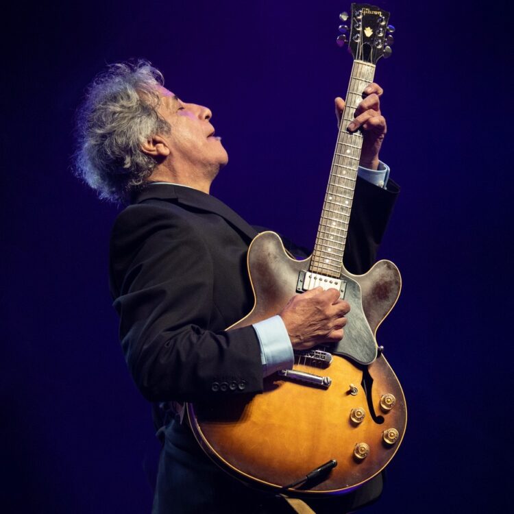 Chris Cain performing with his guitar
