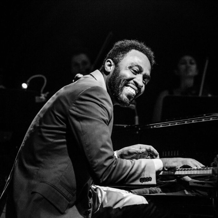 Dayramir Gonzalez performing on stage in black and white