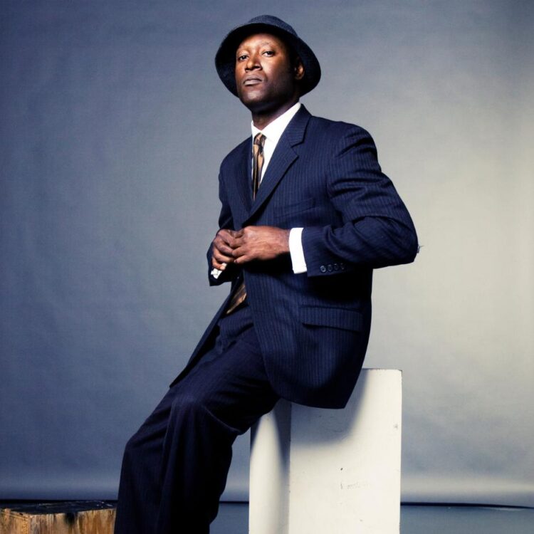 Marcus Shelby leaning against a white box