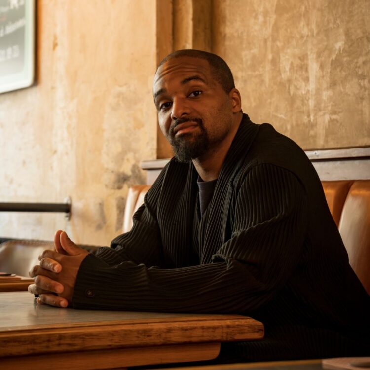 Sullivan Fortner sitting with arms resting on a table