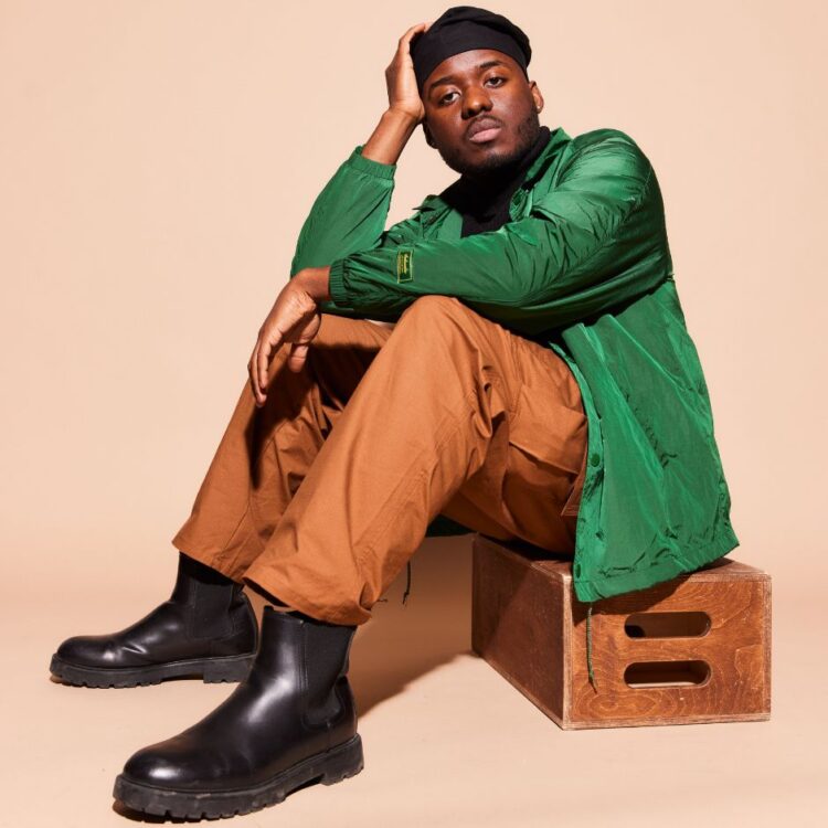 Tyreek McDole sitting on a small box