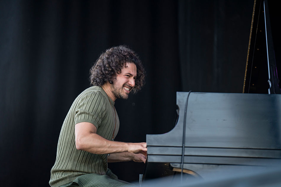 Emmet Cohen performing piano on stage