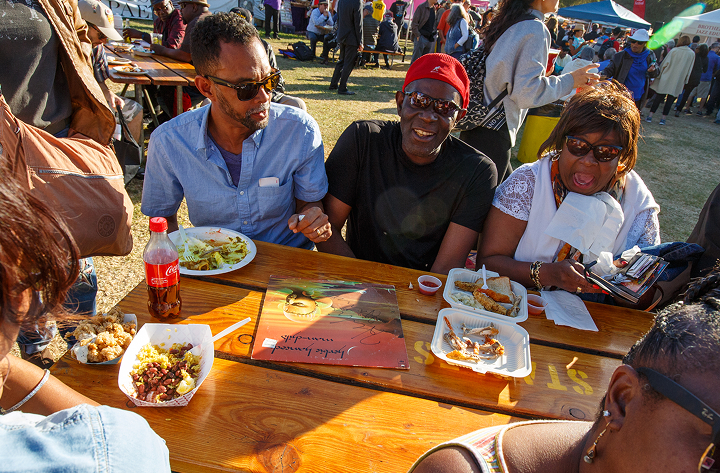Table of guests eating food outside