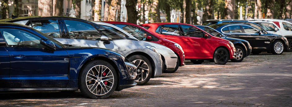 A lineup of different cars parked diagonally