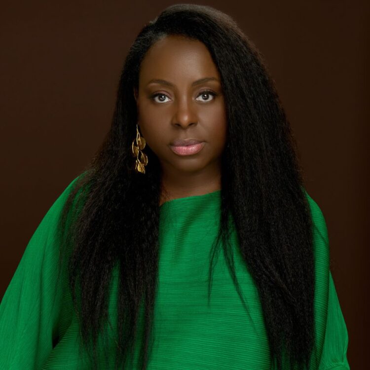 Ledisi standing in front of a brown background