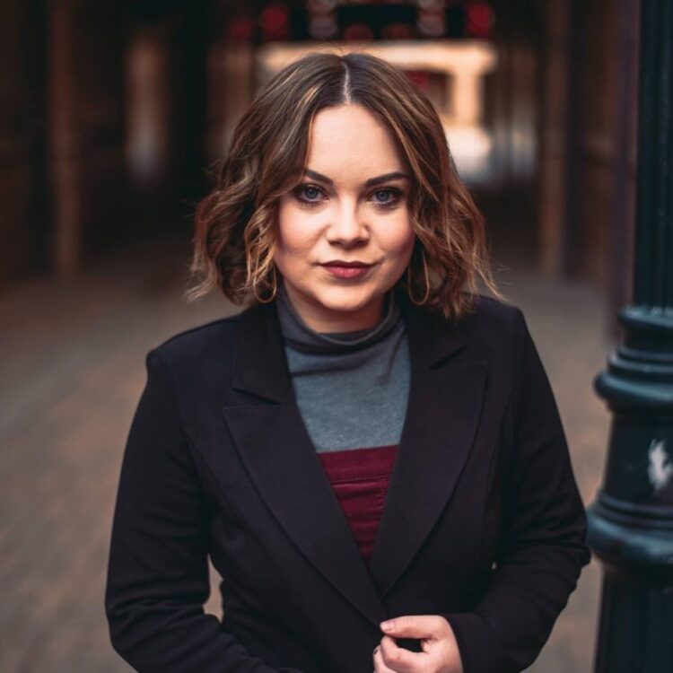 Miranda Perl standing outside in an out of focus alleyway
