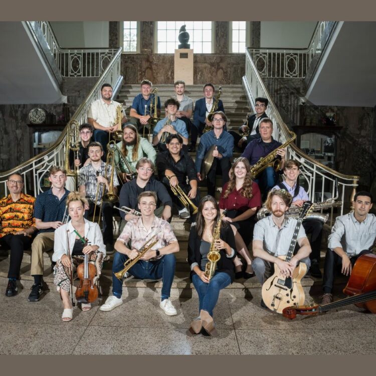 Members of the University of North Texas One O'Clock Lab band sitting on a stair case with their instruments