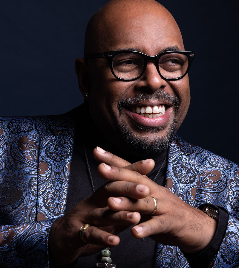 Close up of Christian McBride in front of a dark blue grey background