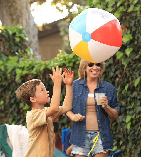 Young audience member playing with a beach ball