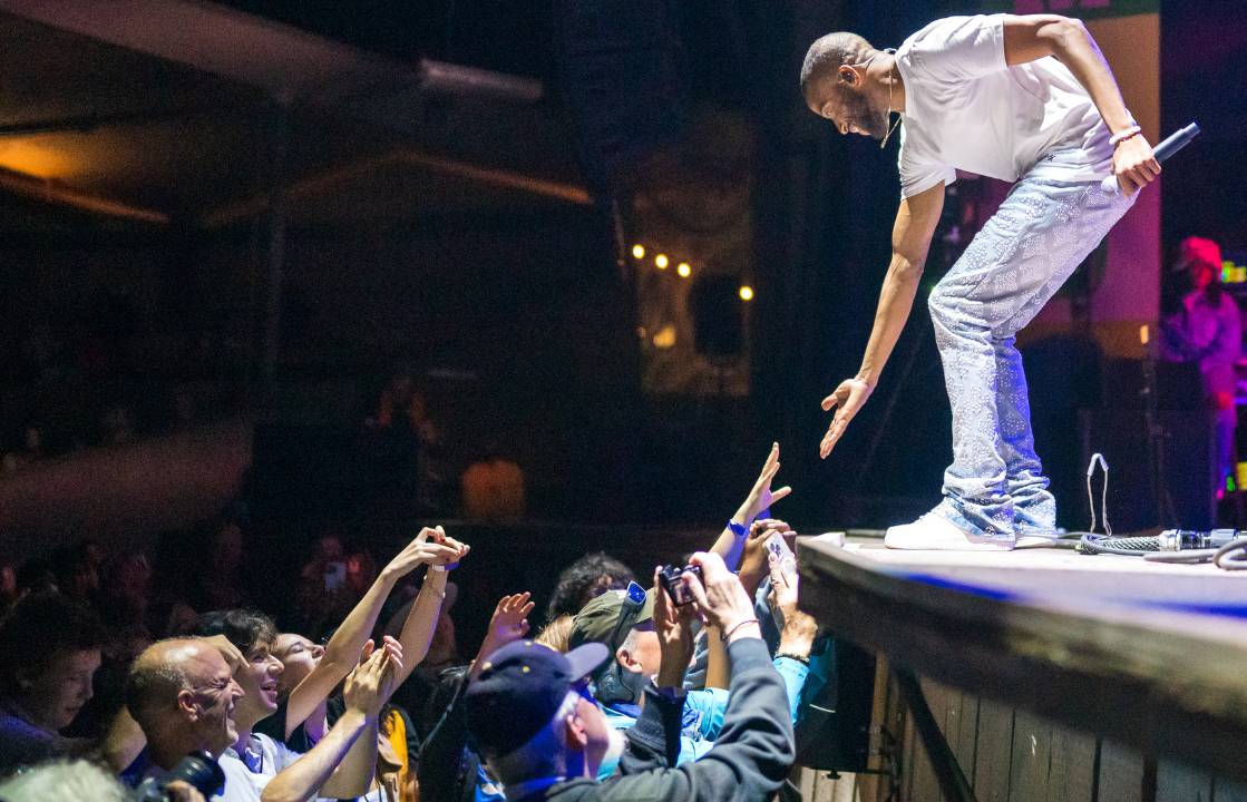 A person on stage with an audience