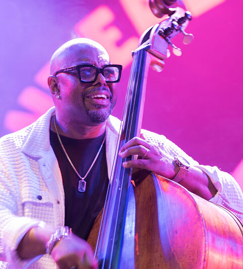 Christian McBride performing on stage with a double bass