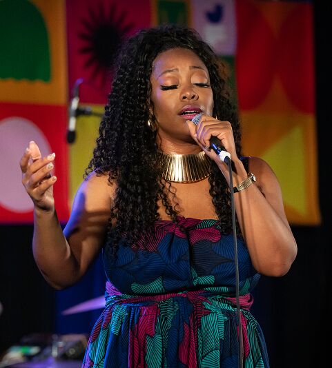 Olatuja singing on stage