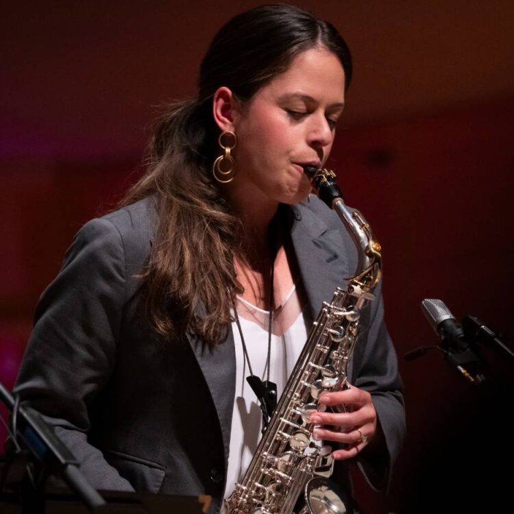 A woman playing saxophone