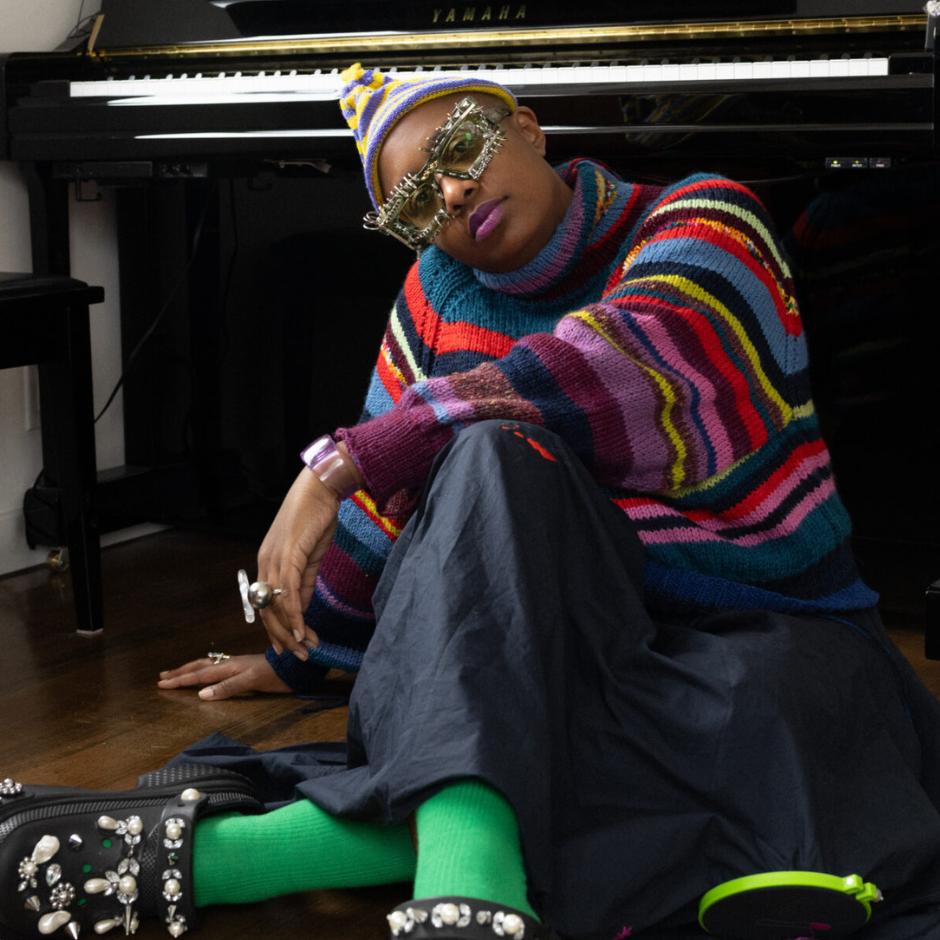 A woman sitting in front of a piano