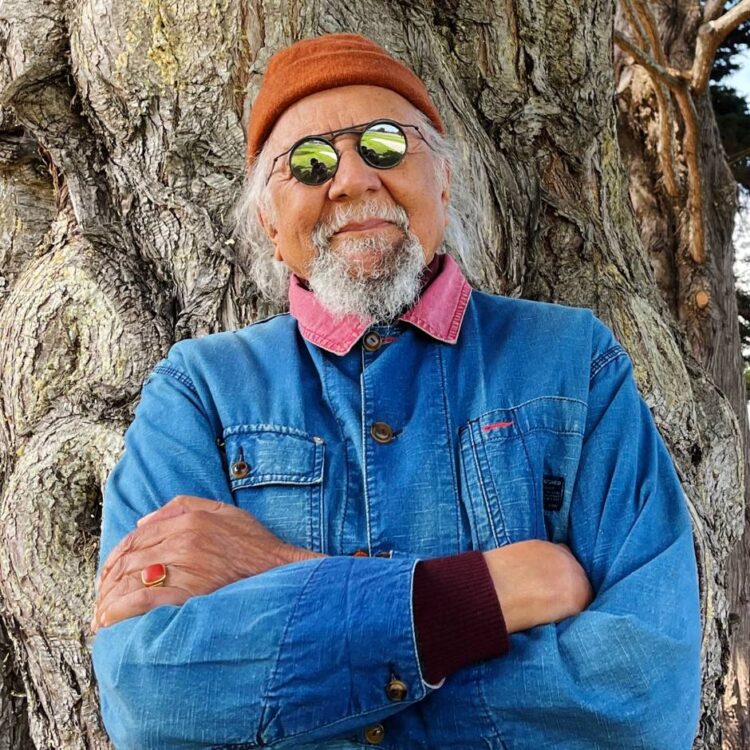 A man standing in front of a tree