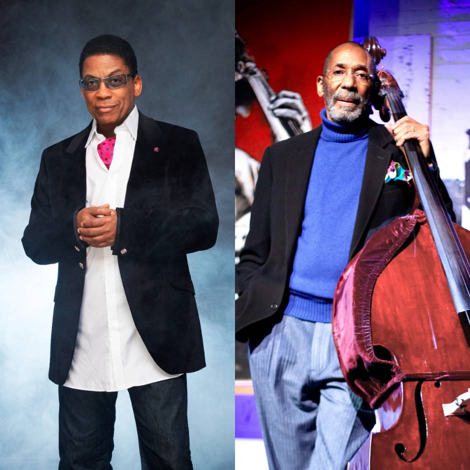 Two men standing, one with a bass