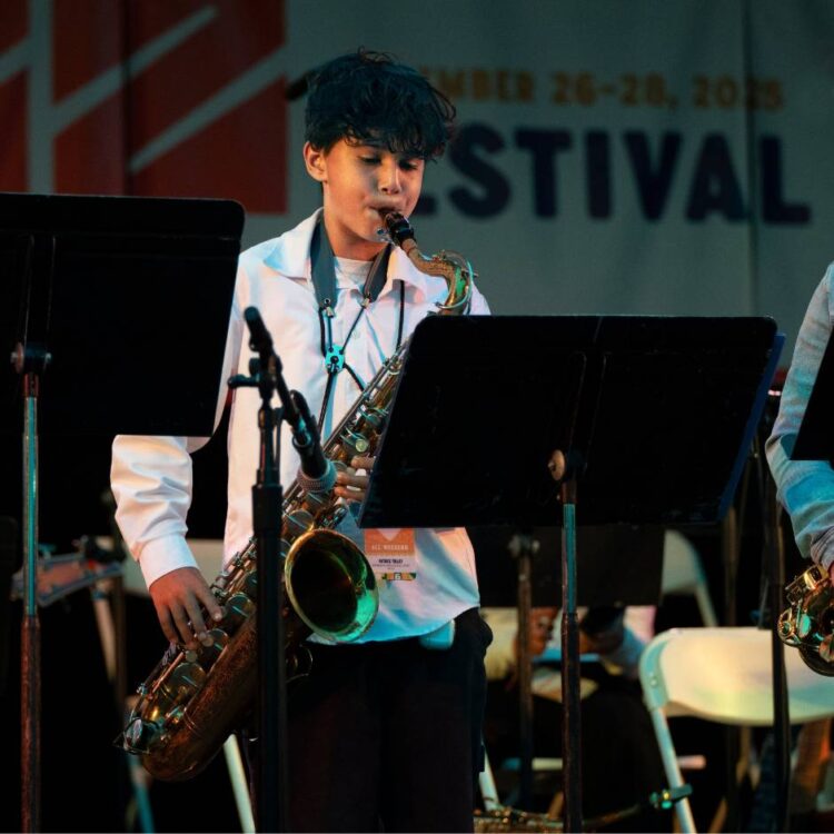 A young person playing saxophone