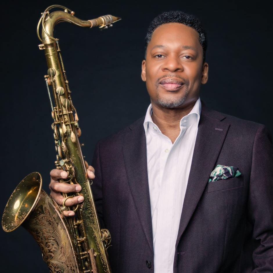 A man holding a saxophone