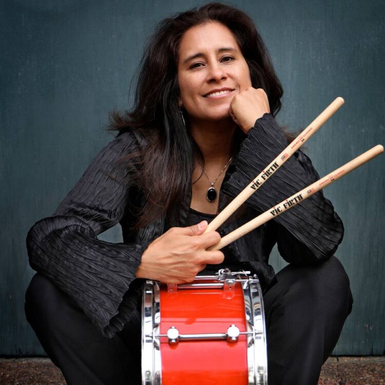 a sitting woman with a drum