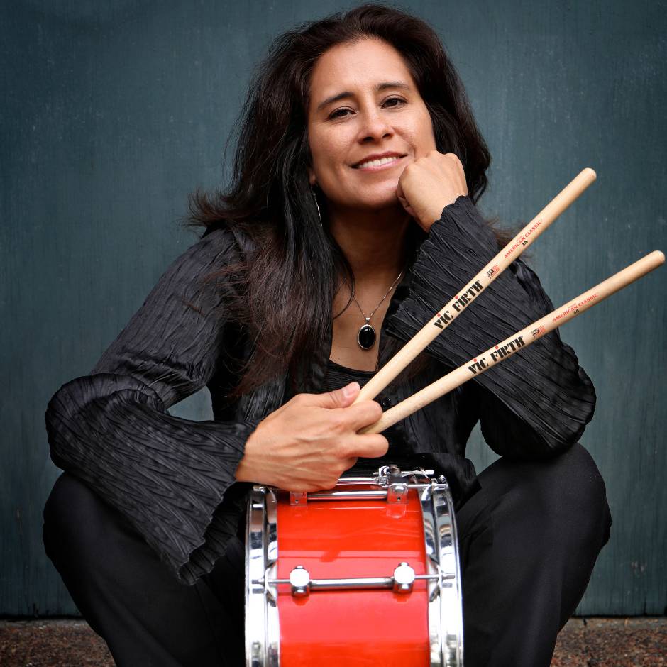 a sitting woman with a drum