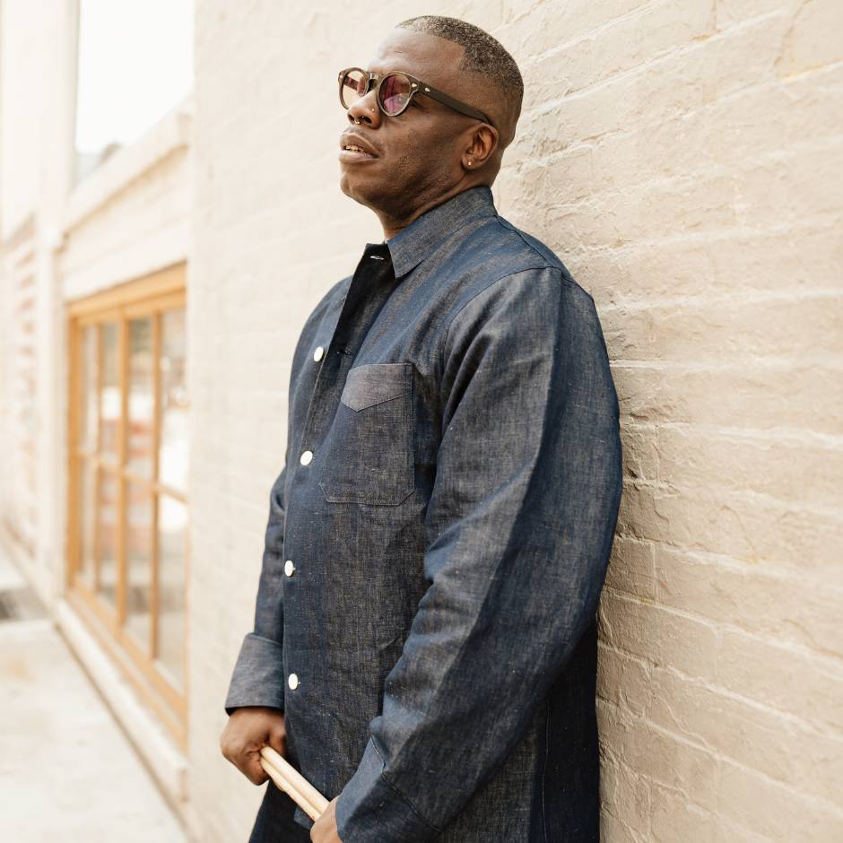 A man standing against a wall