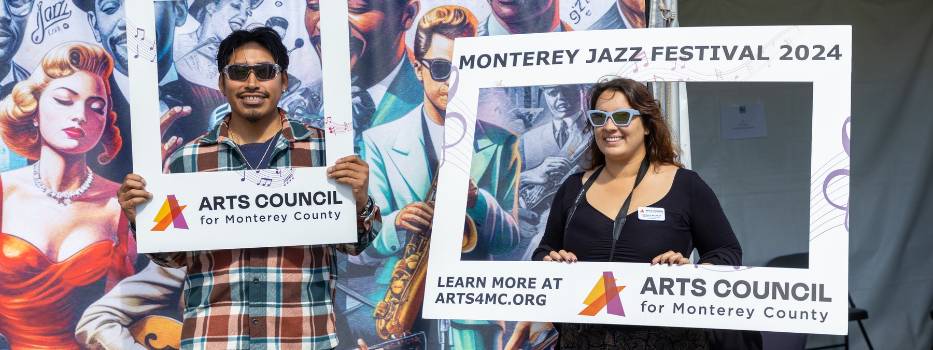 Two people holding signs